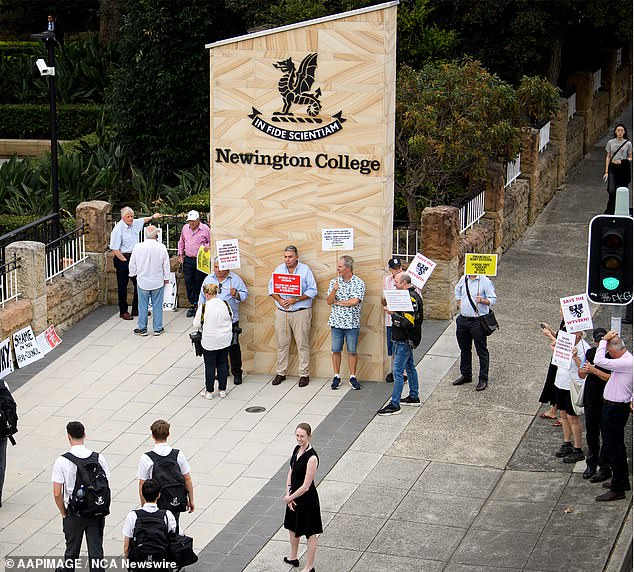 Furious parents have gathered at Newington College (pictured) in Sydney's west, holding signs to protest the school's decision to go co-ed.