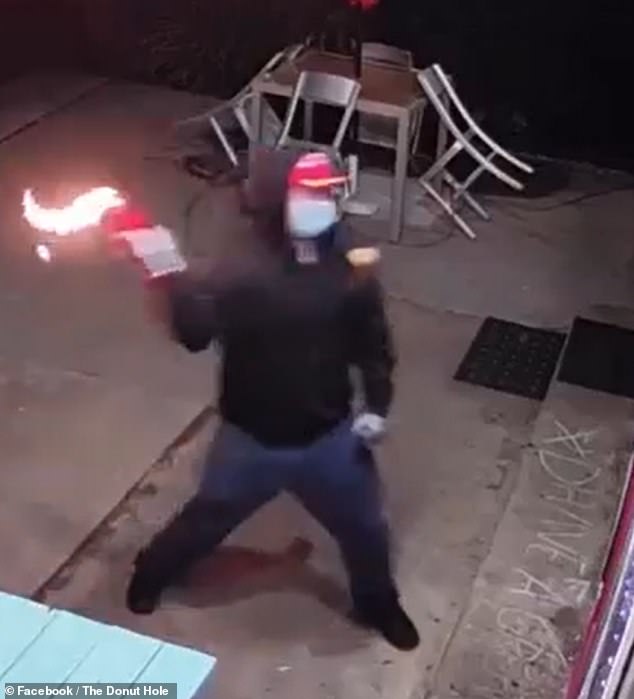 A security camera at the Tucson store captured the moment Green threw his Molotov cocktail through the door he had shattered seconds earlier