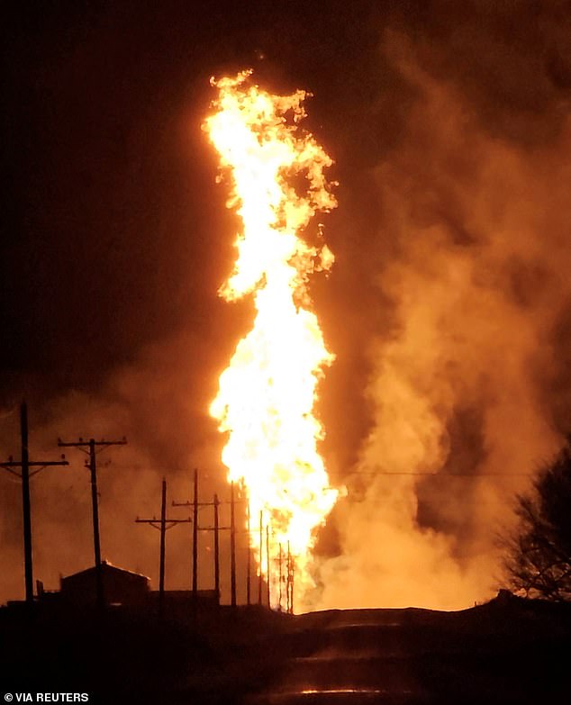 Videos of the explosion posted by officials show scorching flames more than 500 feet high emanating from the blast - burning agricultural fields and power lines in the area