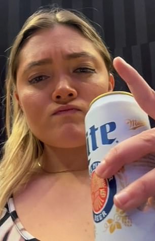 Julz Dunne drinks beer during the LSU-Ohio State meet