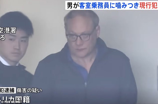 The glasses suspect, reportedly identified as 55-year-old Michael Travis Haliyad, forced the flight to return to Tokyo en route to Seattle on Tuesday evening after allegedly biting a flight attendant