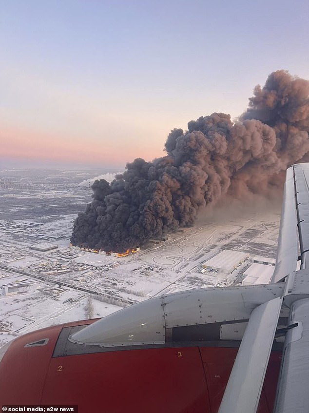 A thick cloud of smoke can be seen coming from the factory.  The massive fire dominated the skyline and was seen by passengers on planes taking off from St. Petersburg Airport