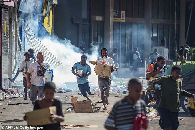 Papua New Guinea's prime minister declared a 14-day state of emergency in the capital on Thursday after 15 people were killed in riots when crowds looted and burned shops (pictured)