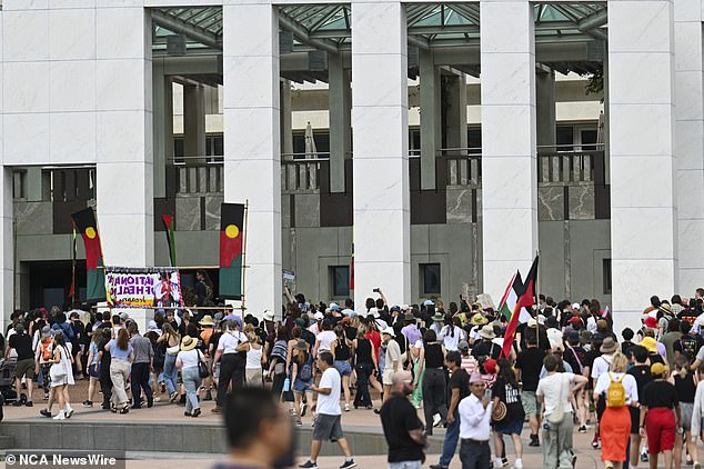 Parliament House has been placed on lockdown after the building was overrun by groups protesting Australia Day and the conflict in the Middle East