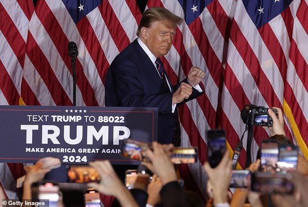 Donald Trump celebrates on stage during his first late-night rally at the Sheraton on January 23 in Nashua, New Hampshire