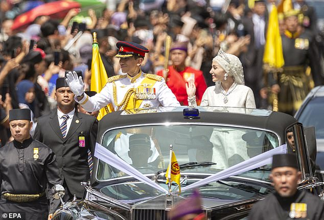 Hundreds of people gathered on the streets of Brunei today to watch Prince Abdul Mateen and his new wife Yang Mulia Anisha Rosnah parade through the capital ahead of their wedding reception