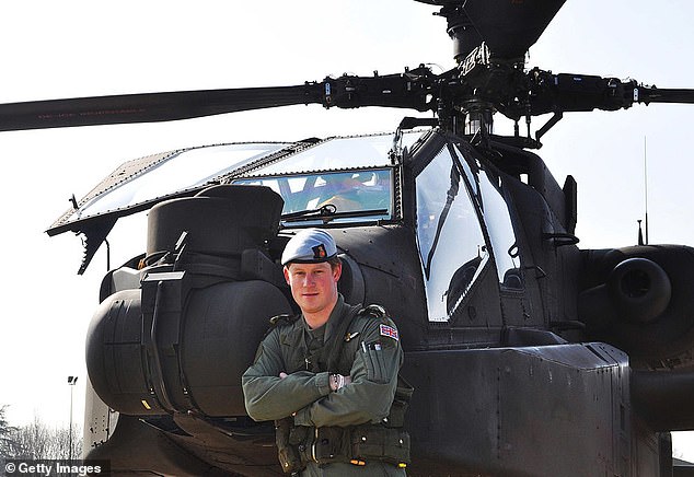 Harry is pictured standing in front of an Apache helicopter in March 2011, just days after the royal family reached the 50-year milestone of becoming a captain in the British Army