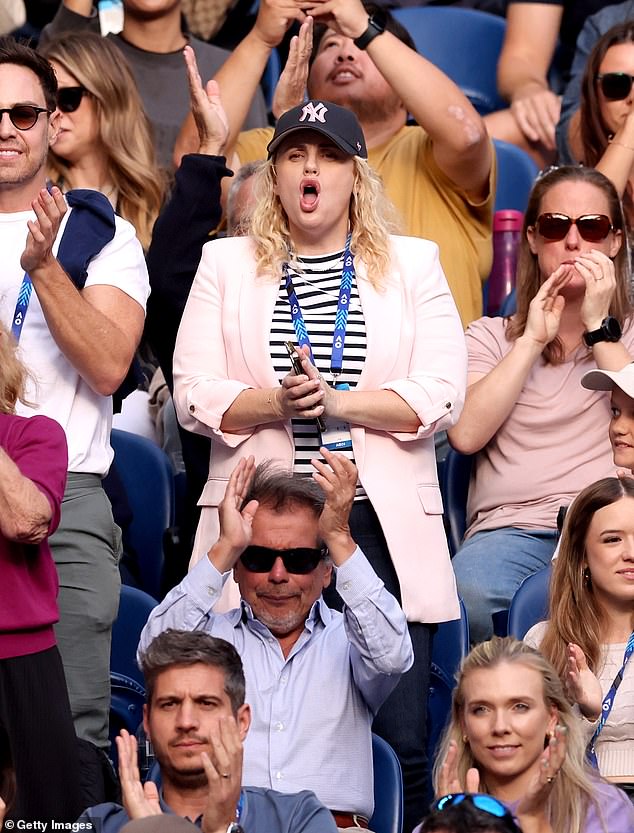 The Australian actress, 43, rocked her best from the stands in a stylish unbuttoned pink blazer which she paired with a black and white striped shirt