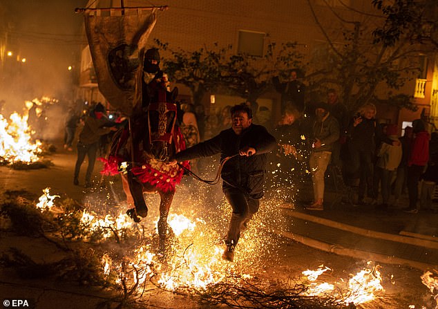 Horses and riders were seen running through flames several meters high in the streets of Vilanova D'Alcolea, in Castellon, eastern Spain