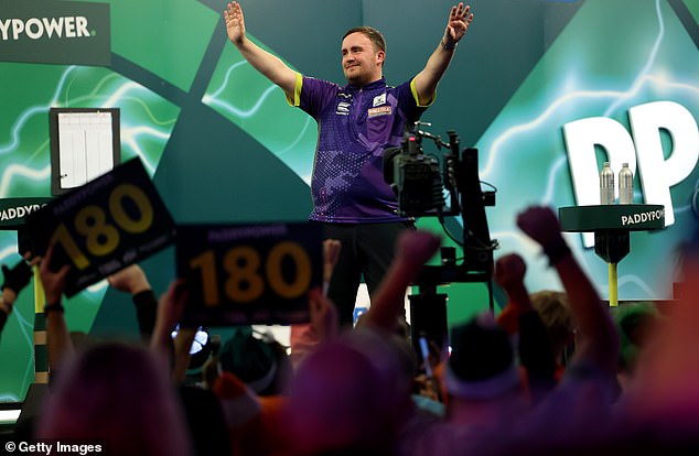 Luke Littler drinks in the cheers after winning his quarter-final against Brendan Dolan, with pundits predicting he will be a millionaire by the end of January