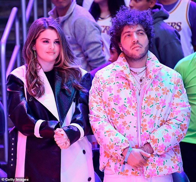 According to body language expert Judi James, Selena Gomez has entered into a 'curative' relationship with Benny Blanco.  The pair are pictured above at a basketball game in LA yesterday