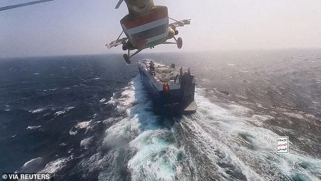 FILE PHOTO: The Houthi military helicopter flies over the Galaxy Leader cargo ship in the Red Sea in this photo released on November 20, 2023