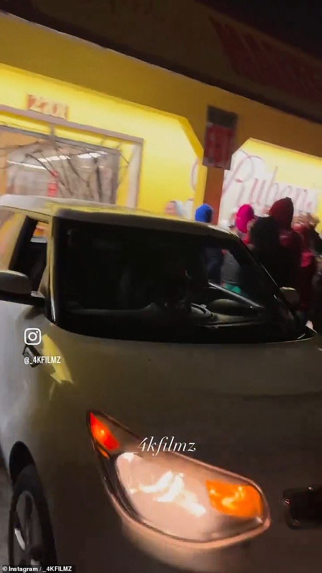 The moment a Kia Soul was reversed through the doors of Ruben's Bakery and Mexican Food in Compton, California is pictured