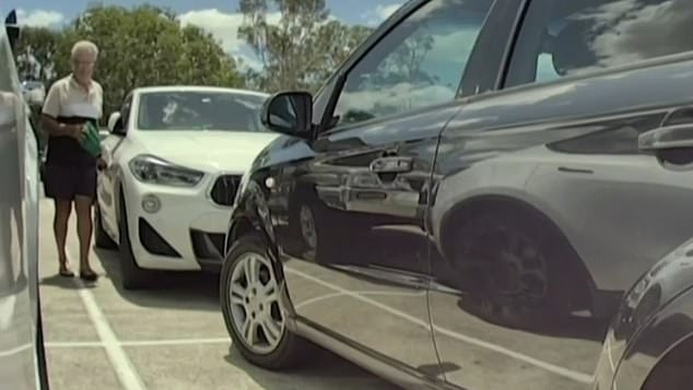 Raymond Edwards and his wife Barbara, both 70, were arrested and fined when they were caught on camera holding cars (pictured) at Brisbane's Brookside Shopping Center