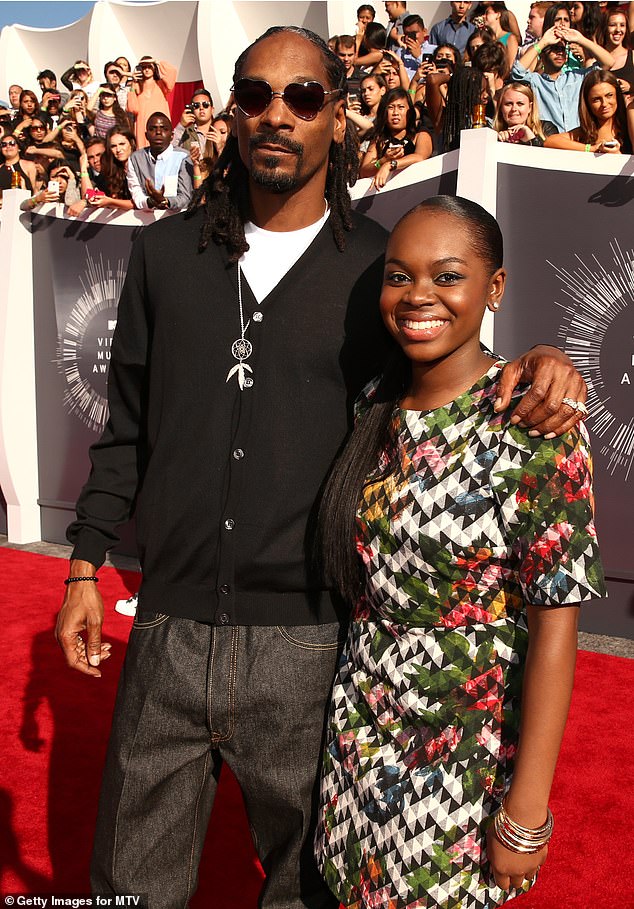 Snoop Dogg has given an update on daughter Cori Broadus, 24, who recently revealed her 'kidneys were doing terribly' after she suffered a stroke;  the father and daughter are seen in Inglewood, California in August 2014