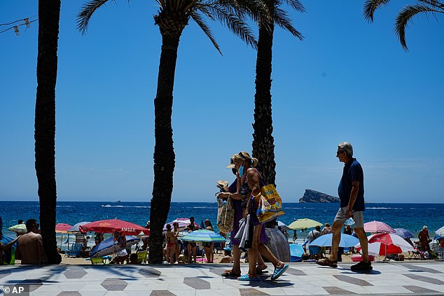 Holidaymakers wear face masks in Benidorm, Spain, in June 2021. The Valencia Health Department today introduced the mandatory use of masks in health centers in locations such as Benidorm due to the increase in respiratory infections