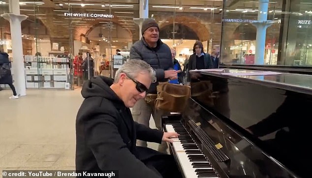 Brendan Kavanagh plays boogie woogie songs on the piano at London's St Pancras station