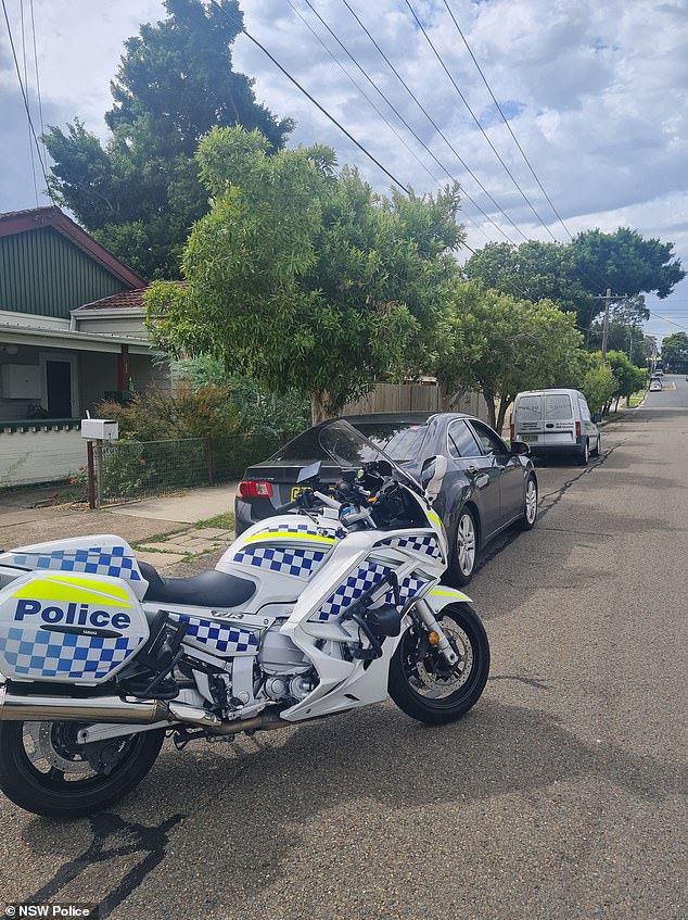 Police stopped the driver and when asked why he had not noticed the fully marked police motorcycle next to his car, he replied: 'I was caught at that moment'