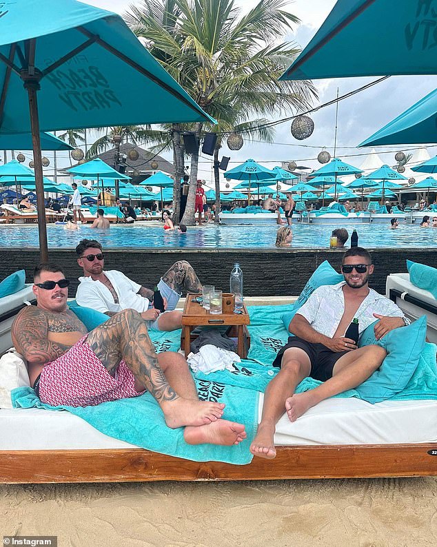 On Friday, just three days before his tragic death, Mr Rockliffe posed with his friends on a sun lounger at the popular Finn's Beach Club on Bali's south coast (pictured)