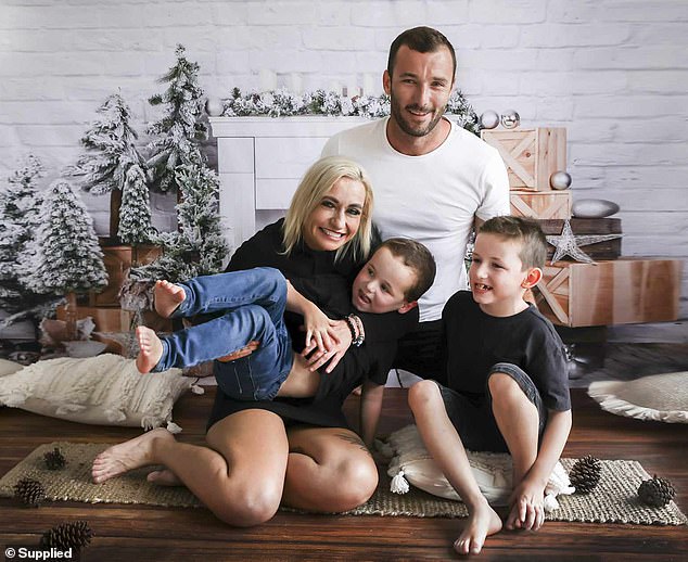 Andrew Pearman is pictured with his partner, Lauren Moore, and two of their three sons: Sage, left, and Braxton, right