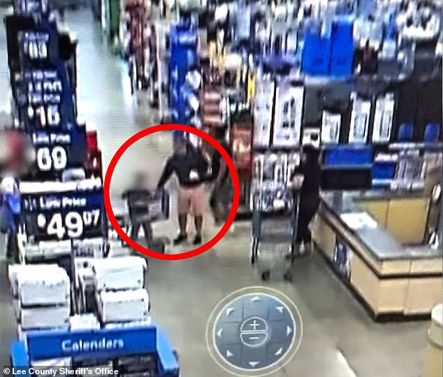 Walmart surveillance footage shows a man walking up to a 4-year-old boy, grabbing his wrist and trying to run away with him