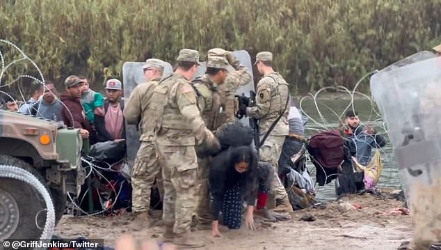 The guards tried to block the path of asylum seekers clambering over barbed wire to reach the US