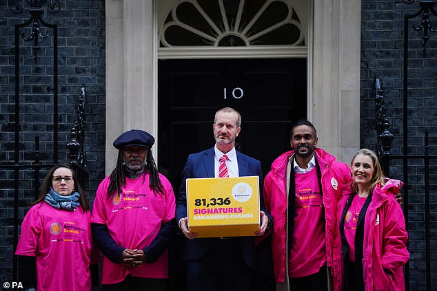 Brain tumor campaigners, (left to right) Antiques Roadshow expert Theo Burrell, TV gardener Danny Clarke, Dan Knowles, CEO of Brain Tumor Research, Sam Suriakumar, a patient undergoing treatment for a brain tumor, and mother of campaigner Laura Nuttall, Nicola Nuttall , posing with their autograph box before handing in a petition at 10 Downing Street, London