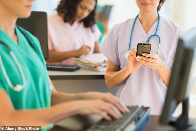 AI robots could soon take some of the burden off exhausted nurses by answering patients' questions and completing simple tasks (Stock Image)