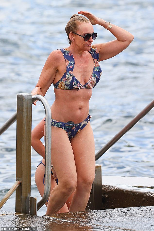 Toni looked relaxed as pictured as he emerged from the ocean in a blue floral print bikini set