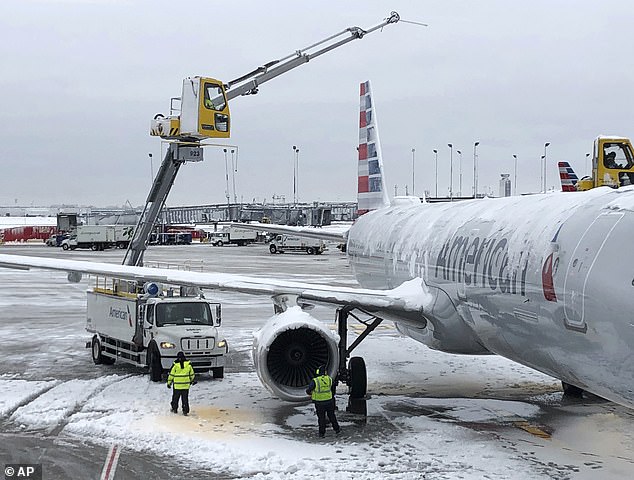 Average departure delays at Chicago's O'Hare International Airport were 77 minutes, the Chicago Department of Aviation said early Monday;  Crews are working in Chicago on Monday to defrost an American Airlines plane at O'Hare International Airport