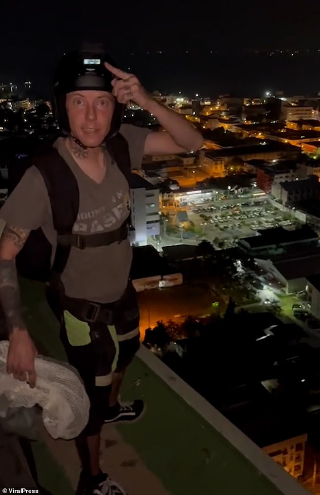 Nathy Odinson, 33, from Huntingdon, Cambridgeshire, climbed to the 29th floor of a block of flats in the coastal town of Pattaya on Saturday evening before dying (pictured: moments before his death)