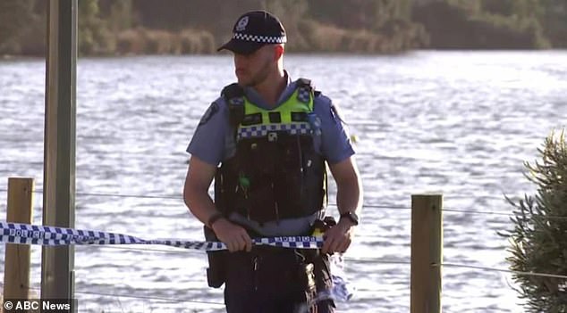 A police officer is pictured at the scene in Perth where two young children drowned