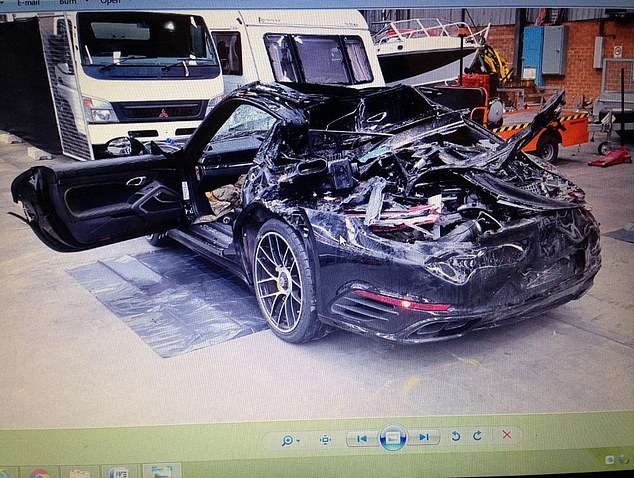 Pictured: Pusey's wrecked black 2016 Porsche 911