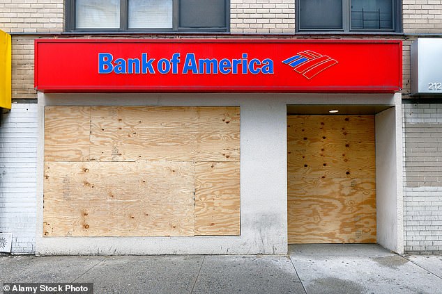 Over the past decade, U.S. banks have closed about 13,000 branches.  The photo shows a closed branch of Bank of America in New York