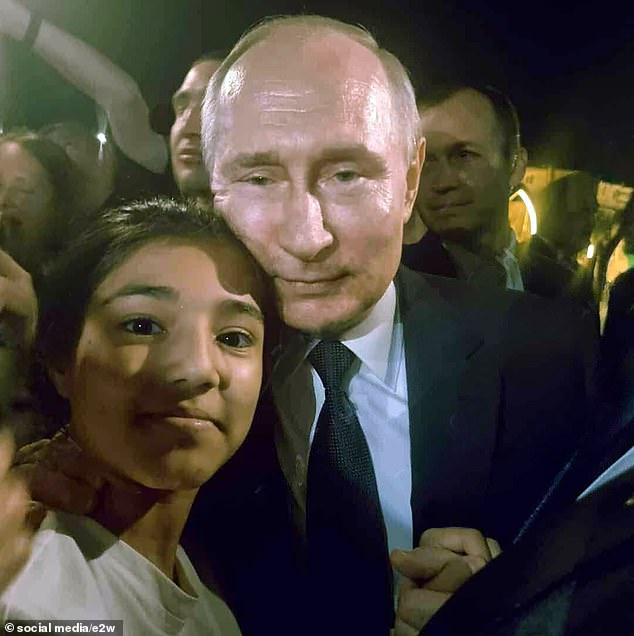 Russian President Vladimir Putin takes a selfie with an admiring teenager from Dagestan on Wednesday during a visit, days after Wagner's failed coup