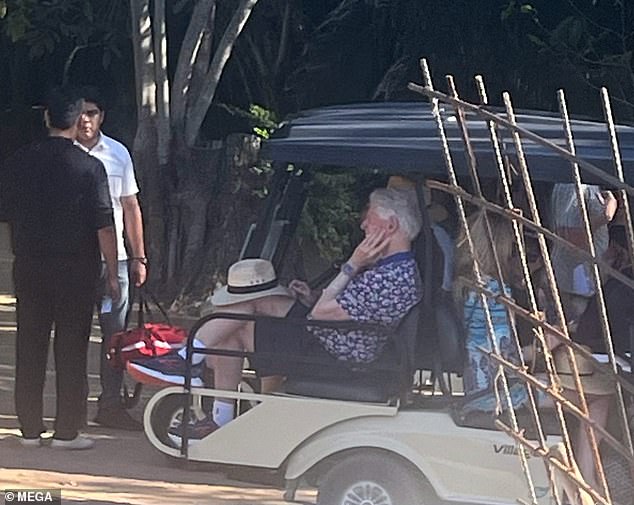 A relaxed-looking Bill Clinton, hat on his knee, is seen in a golf cart with the Newsoms at the Four Seasons in Tamarindo, Mexico