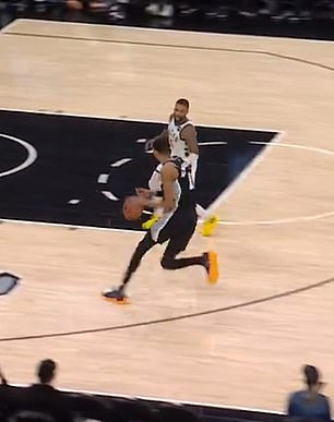 Victor Wembanyama dribbles towards Damian Lillard