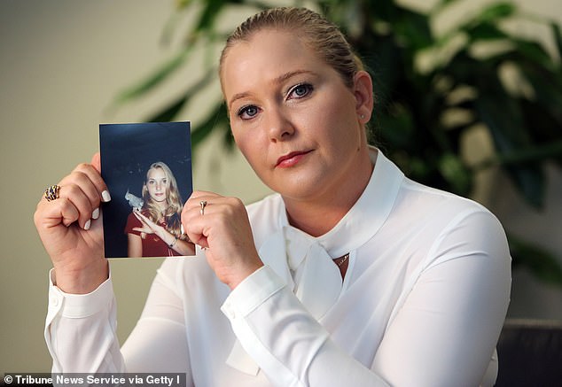 Virginia Roberts Giuffre holds a photo of herself at age 16 when she says Palm Beach multimillionaire Jeffrey Epstein began sexually abusing her