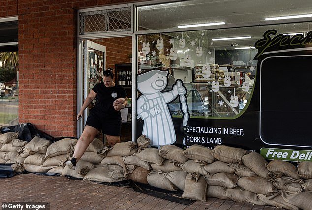 Several regions saw record-breaking rain (photo, sandbagged butcher in Rochester)