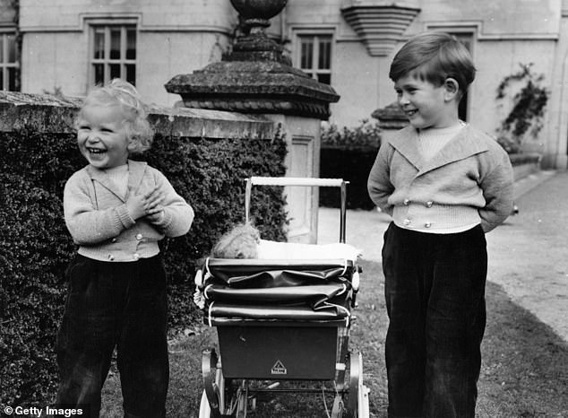 Princess Anne and Prince Charles laugh together in the grounds of Balmoral Castle