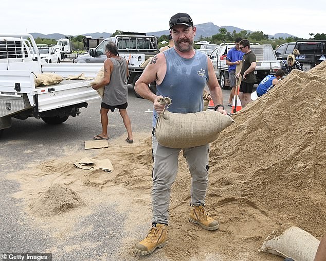 Townsville residents are filling sandbags before the system makes landfall this evening