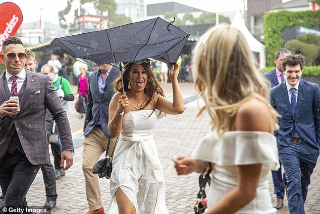 Four months later, the east of the country is drenched in rain and flooding and there is not much improvement in sight.  A woman is shown laughing as her umbrella turns inside out in the wind and rain