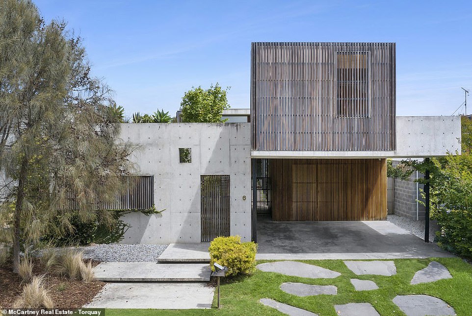 Behind the facade of this bold concrete building lies a warm, sun-drenched family home with a cactus garden on the roof, dazzling modern décor and a generous master bedroom.