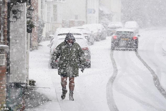 Snow fell in Britain today as temperatures dropped to -7C (19F), with more ice warnings and an amber health warning for the rest of this week (Picture: PA)