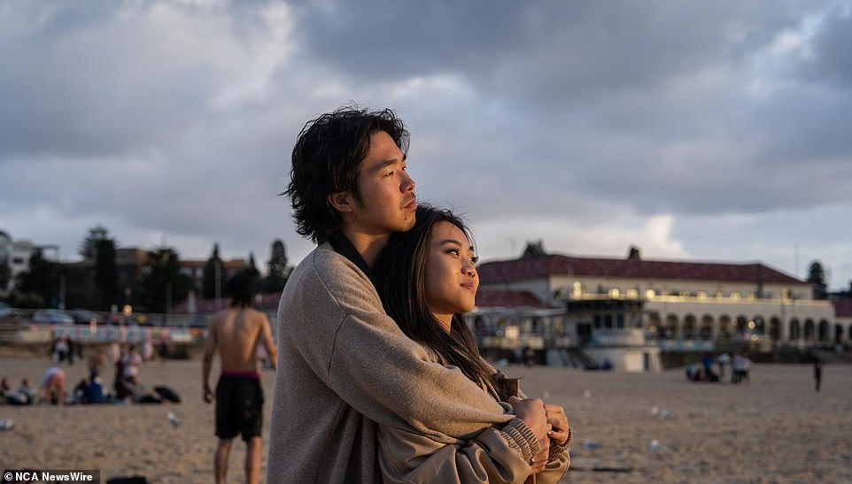 A couple cuddled as they watched the sunrise on Bondi Beach