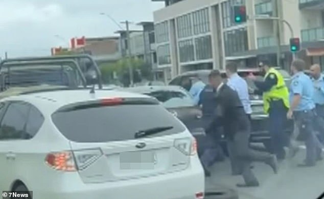 The wild chase ended 90 minutes after it started and the woman was dragged from her car (pictured)