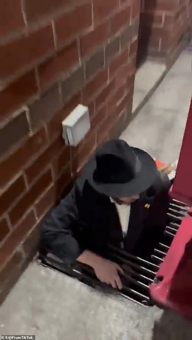 A man is seen emerging from the tunnels beneath the synagogue