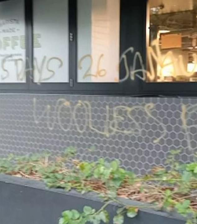 Vandals have spray-painted the message: '5 days 26 Jan Aussie Aussie Oi Oi Woolies f*** u' on the front of the Woolworths Metro store in Teneriffe, Brisbane (pictured)