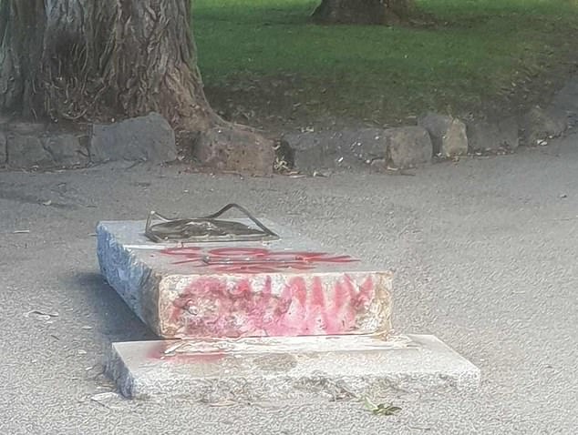 The Captain Cook plaque, located at the Rowe Street entrance to Edinburgh Gardens in Fitzroy North, Melbourne, was toppled by vandals who spray-painted 'Cook the Colony' on the base