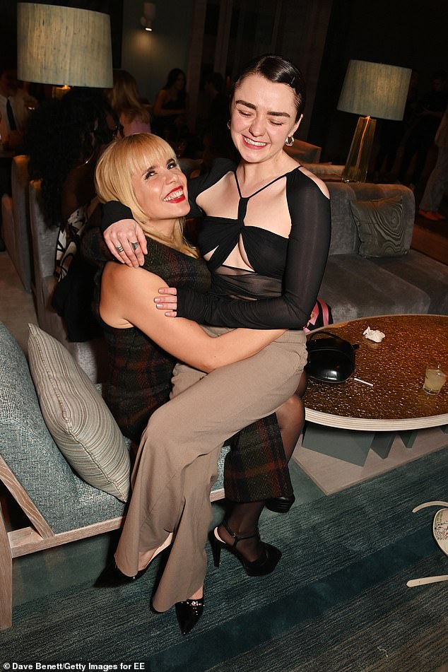 At the party, she was seen catching up with singer Paloma Faith while she was affectionately perched on her knee